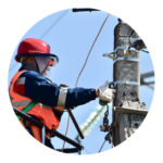 Electrician working on infrastructure electric pole