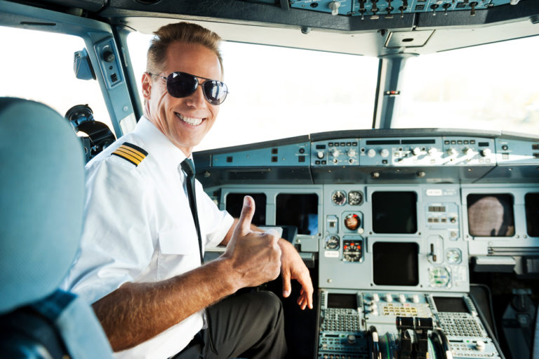 Commercial Pilot smiling in the cockpit with his thumb up