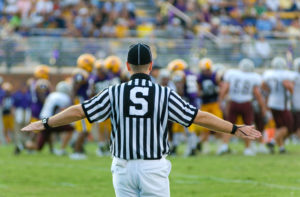 American Football Sports Referee at work on the field