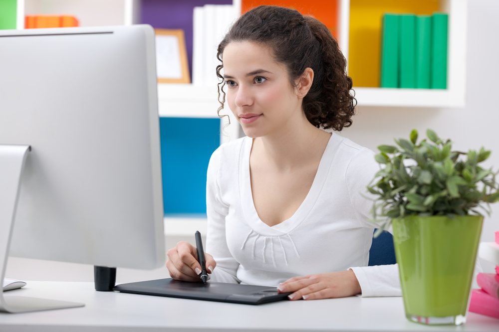 Female Web designer designing behind her desk
