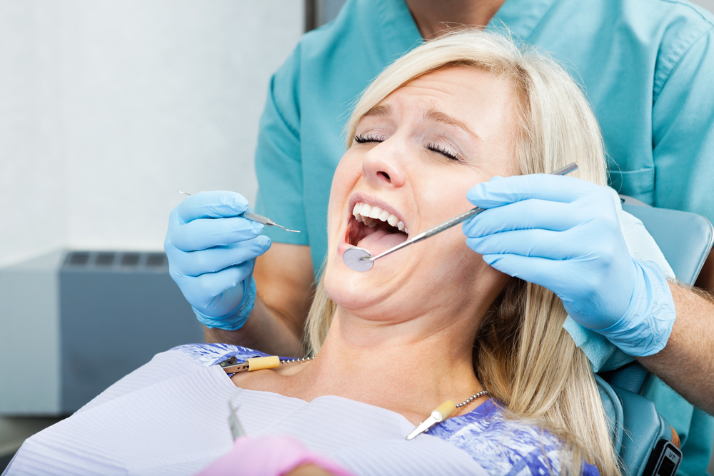 Mouth hygienist helps a young female patient at clinic